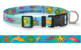 A colorful dog collar with an aquatic animal pattern including dolphins, sea turtles, and jellyfish, featuring a black buckle and customizable webbing.