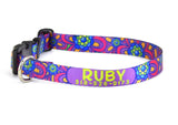 Personalized dog collar with Ruby's name and phone number on a purple and pink flower background.